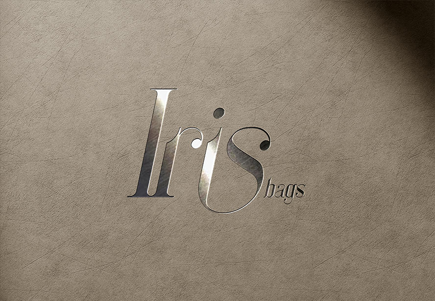 IRIS Bags Embossed Logo – Distinctive and refined branding imprinted on beige leather, emphasizing luxury and attention to detail.